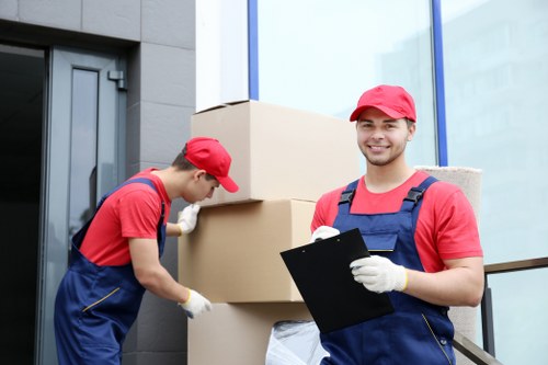 Moving team handling furniture during home moves in Swisscottage