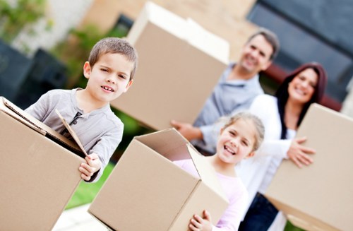 Professional movers handling furniture during house removals in Swisscottage