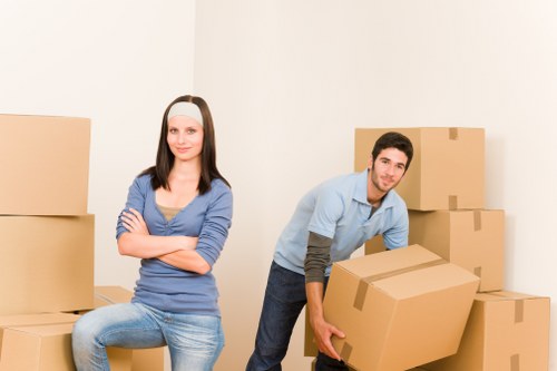 Worker assessing boxes and lifting methods before a move