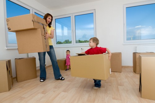 Professional man and van service handling packed boxes in Swisscottage