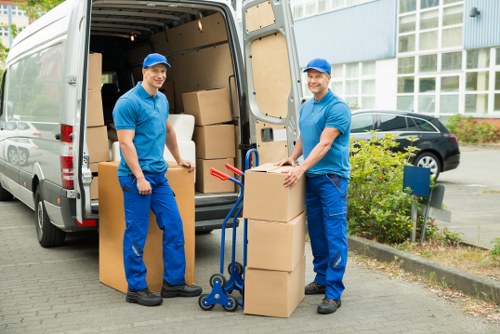 Packed moving boxes and furniture prepared for removal in Swiss Cottage