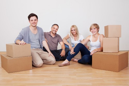Professional movers carrying furniture during a same-day removal in Swiss Cottage